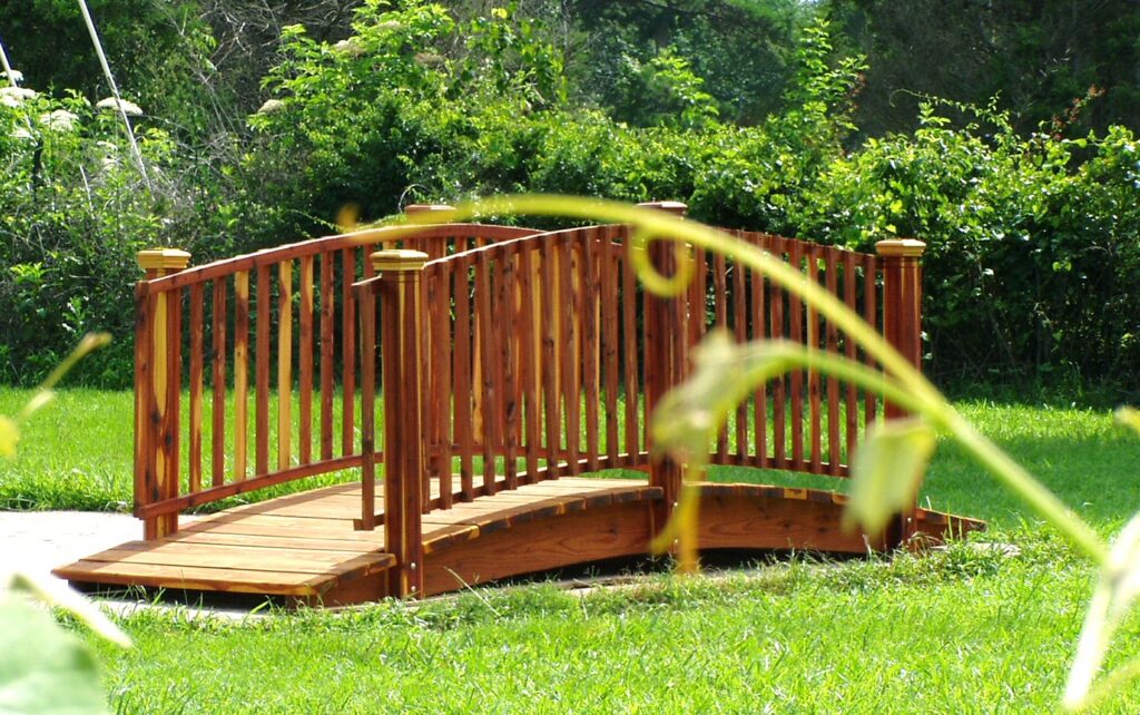 8-foot handcrafted red cedar garden bridge with spindle railings" Cedar Spindle rail bridge ", built in the USA by Redwood Bridges.