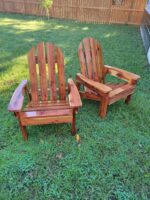 Pair of handcrafted cedar Adirondack chairs made from Eastern Red Cedar, ideal for patios, porches, and gardens.
